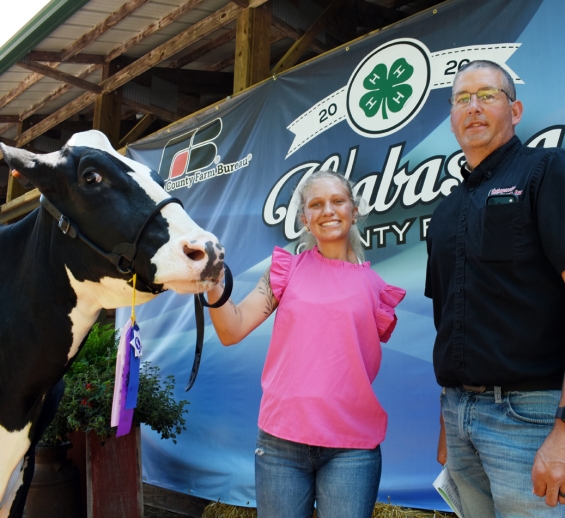 Abby Fick of the West Albany Winners with a representative of buyer MN Ag Group.