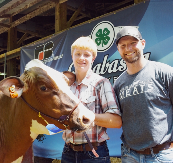 Charlie Fort of the Gillford Golden Gophers with a representative of buyer Millville Valley Meats.