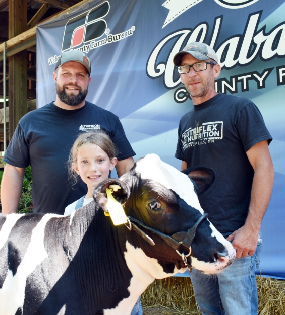 Hailey Klein of the West Albany Winners with representatives of buyers Nutriflex Ag and Atkinson Construction.
