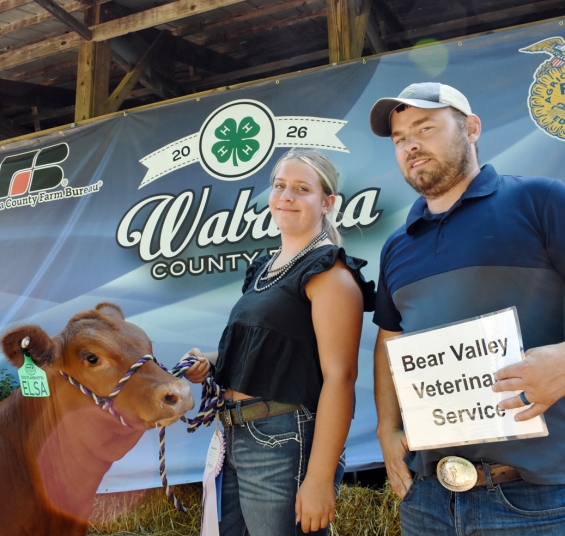 Julia Atkinson of the Gillford Golden Gophers with a representative of buyer Bear Valley Vet Services.