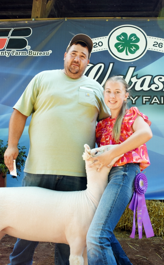 Kara Schrock of the West Albany Winners with a representative of buyer Tesmer Valley Livestock.