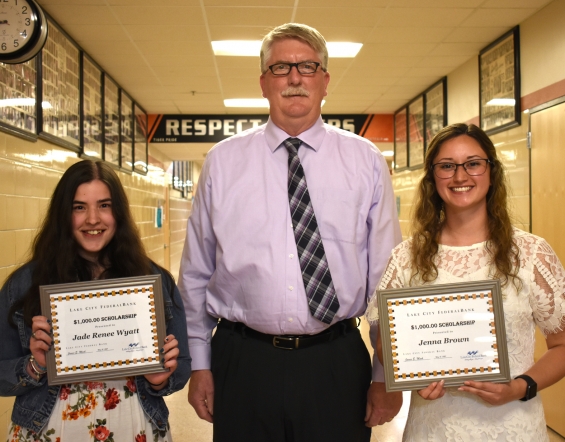 Lake City Federal Bank Scholarship - two $1,000 awards. From left: recipient Jade Wyatt, presenter Jim Mack, and recipient Jenna Brown.