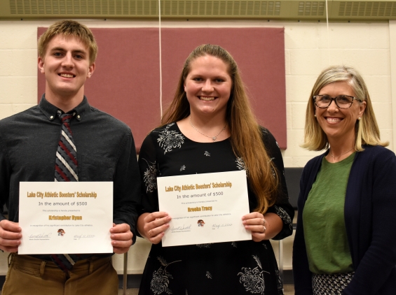 Lake City Athletic Booster Club. Two $500 awards. From left: recipients Kristopher Ryan and Brooke Tracy, and presenter Dena Huettl.