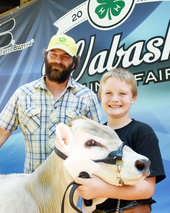 Mitchell Beltz of the West Albany Winners with a representative of buyer Holst Farms.