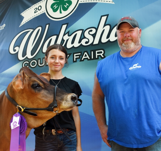 Trinity Peters of the Gillford Golden Gophers with a representative of buyer Wabasha County DHIA.