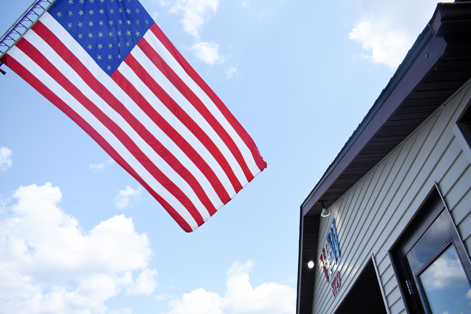The Lake City Fire Department garrison flag flies over the Lake City VFW during Capt. Monty Vikdal’s promotion ceremony.