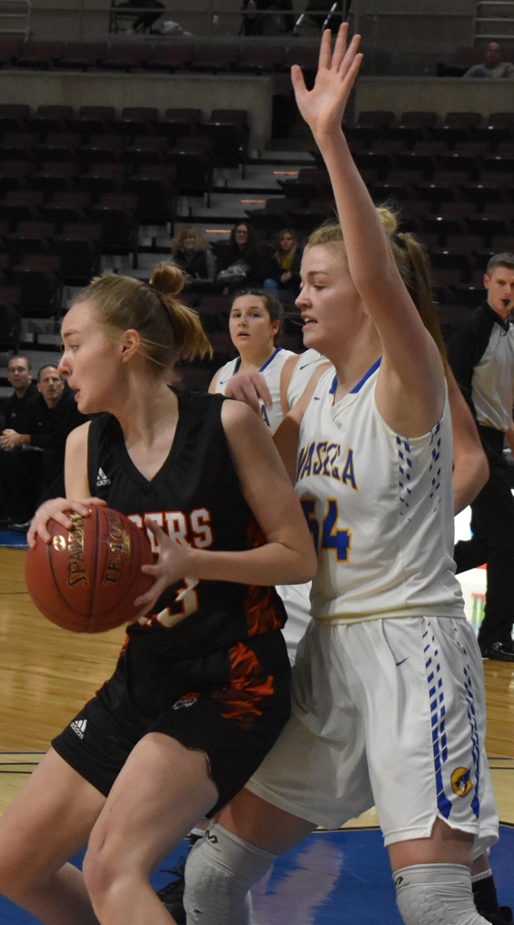 Grace Bany looks inside for Mya Shones against Waseca Jan. 4.