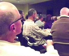 Don Schwartz used a hand-held remote to rate one of several goals and objectives reviewed by 112 people at Tuesday night’s big tent meeting at St. Mary of the Lake Catholic Church.